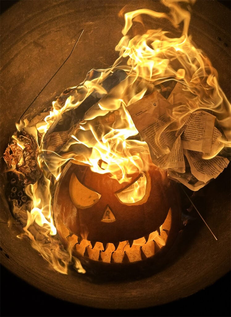 Burning pumpkin with flames and paper inside, spooky Halloween decoration at Pudsey Camera Club.