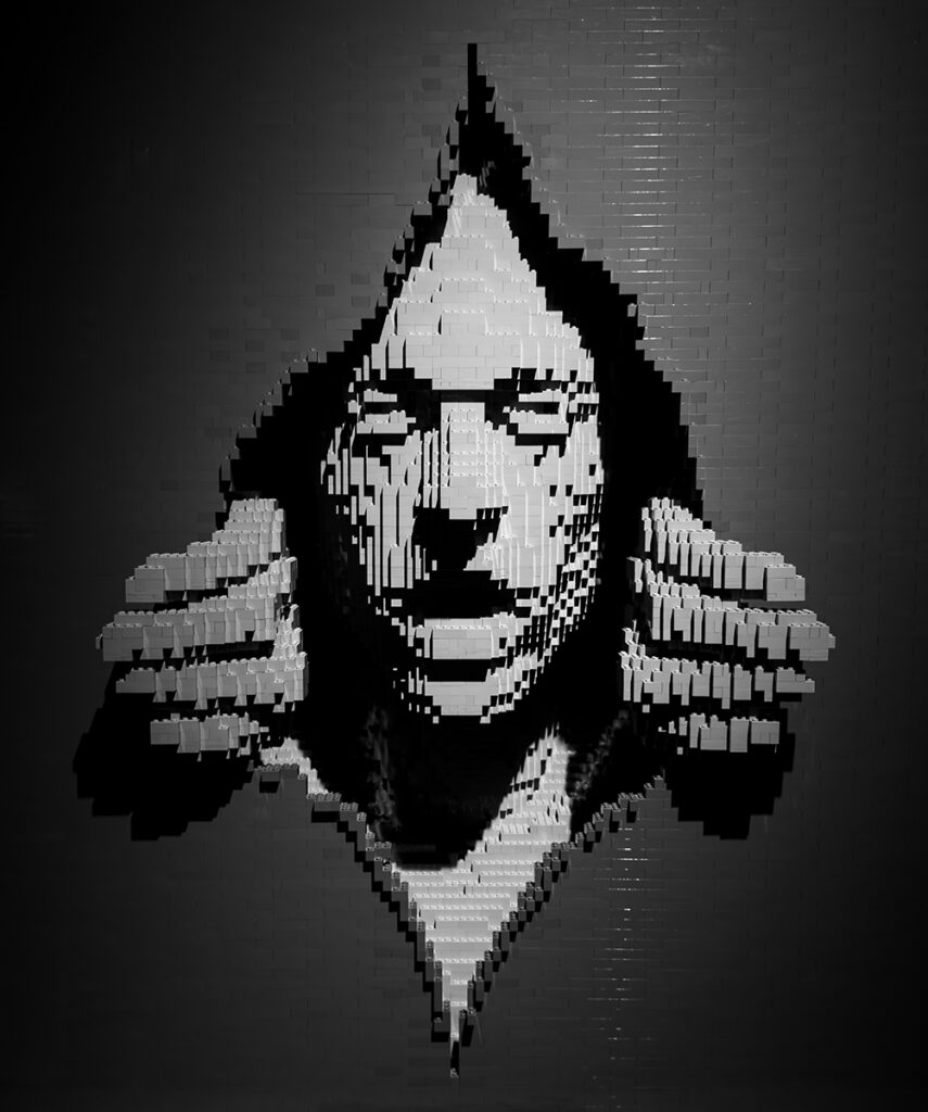 Pixel art of a person with glasses and a hood, Pudsey Camera Club.