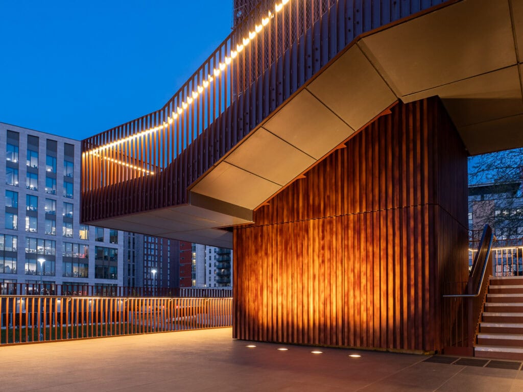Contemporary building with illuminated accents and wooden facade at night, Pudsey Camera Club.